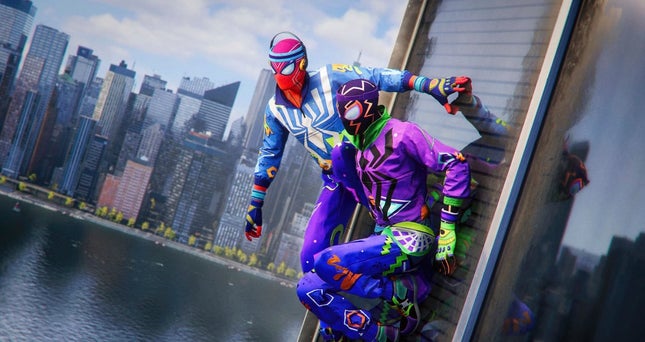 Miles and Peter dressed in extravagant spider suits while hanging on the side of a building.
